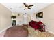 Comfortable living room featuring a decorative ceiling fan, a large window, and a view of other rooms at 1716 Terry Ne Cir, Winter Haven, FL 33881