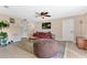 Cozy living room with decorative ceiling fan and view into other rooms at 1716 Terry Ne Cir, Winter Haven, FL 33881