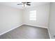 Cozy bedroom with a ceiling fan, neutral paint, and a window offering natural light at 1721 Sandalwood Sw Cir, Winter Haven, FL 33880