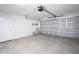 Spacious two-car garage with concrete flooring, white walls, and an automatic door opener at 1721 Sandalwood Sw Cir, Winter Haven, FL 33880