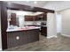 Kitchen featuring an island with a sink, white countertops and cabinets, with stainless steel appliances at 1721 Sandalwood Sw Cir, Winter Haven, FL 33880