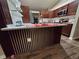 Kitchen featuring an island with a sink, white countertops and cabinets, with stainless steel appliances at 1721 Sandalwood Sw Cir, Winter Haven, FL 33880