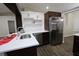 Kitchen featuring an island with a sink, white countertops and cabinets, with stainless steel appliances at 1721 Sandalwood Sw Cir, Winter Haven, FL 33880