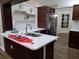 Modern kitchen showcasing sleek countertops, a stylish backsplash, and dark wood flooring at 1721 Sandalwood Sw Cir, Winter Haven, FL 33880