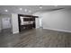 Spacious living room view into kitchen with hard wood floors and bright natural light at 1721 Sandalwood Sw Cir, Winter Haven, FL 33880