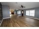 Spacious living room with hardwood floors, a ceiling fan, and abundant natural light at 1721 Sandalwood Sw Cir, Winter Haven, FL 33880