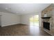 Spacious living room with hardwood floors, fireplace, and sliding door at 1721 Sandalwood Sw Cir, Winter Haven, FL 33880