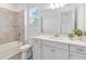 Bathroom featuring shower, bathtub, mirror, and vanity with white cabinets at 18441 Mowry Ct, Orlando, FL 32827