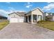 Charming single-Gathering home featuring a 2-car garage and brick paved driveway at 18441 Mowry Ct, Orlando, FL 32827