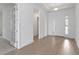 Bright foyer featuring a front door, sidelight window, and ceramic floors at 18441 Mowry Ct, Orlando, FL 32827