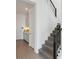 Hallway view showcasing stairs with black railing, gray flooring, and built-in cabinets at 18441 Mowry Ct, Orlando, FL 32827