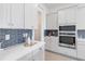 Bright kitchen featuring white cabinets, subway tile backsplash, stainless steel appliances and quartz counters at 18441 Mowry Ct, Orlando, FL 32827