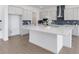 Spacious kitchen featuring a white island, modern appliances, and a blue backsplash at 18441 Mowry Ct, Orlando, FL 32827