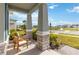 View from the covered front porch showing outdoor seating and neighborhood at 18441 Mowry Ct, Orlando, FL 32827