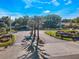 Aerial view of community entrance with tropical palm trees, colorful landscaping, and convenient access at 2019 Dixie Belle Dr # 2019W, Orlando, FL 32812