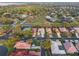 This aerial shows homes lining a neighborhood street, some with pools, lush green trees and landscaping in a well maintained community at 204 Lake Region S Blvd, Winter Haven, FL 33881