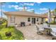 Paver patio and manicured lawn in a private backyard featuring mature landscaping and grill at 204 Lake Region S Blvd, Winter Haven, FL 33881