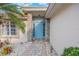 Inviting blue front door with stone accents, decorative plants, and a brick paver walkway at 204 Lake Region S Blvd, Winter Haven, FL 33881