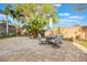 Well-designed outdoor area with brick privacy walls, mature landscaping, and outdoor dining table at 204 Lake Region S Blvd, Winter Haven, FL 33881