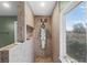 Bathroom shower with tile surround, shower head, shelving, and natural light from the window at 2040 Touchwood Ct, Apopka, FL 32712