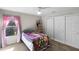 Bright bedroom with a cozy quilt, a window with pink curtains, and a ceiling fan at 2040 Touchwood Ct, Apopka, FL 32712