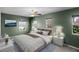 Green bedroom with white furnishings, windows, and natural light at 2040 Touchwood Ct, Apopka, FL 32712