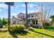 Two story home with blue shutters, mature landscaping and a manicured lawn at 2040 Touchwood Ct, Apopka, FL 32712