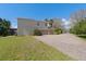 Rear exterior view showing a two-story house with a large driveway and spacious grassy area at 2040 Touchwood Ct, Apopka, FL 32712