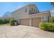 Exterior of a three-car garage, providing ample parking and storage space at 2040 Touchwood Ct, Apopka, FL 32712