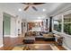 Open-concept living room with hardwood floors, natural light, and an adjacent kitchen at 2040 Touchwood Ct, Apopka, FL 32712