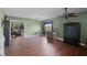 Cozy living room with wood floors, a ceiling fan, and a large window at 2040 Touchwood Ct, Apopka, FL 32712