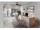 Bright home office with a modern desk, chair, bookcase, and natural light from the window at 2040 Touchwood Ct, Apopka, FL 32712