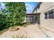 Backyard patio with a brick surface, firepit, and lush landscaping at 2040 Touchwood Ct, Apopka, FL 32712