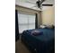 Bedroom featuring a large window and a dark blue bedspread at 2047 Dixie Belle Dr # 2047K, Orlando, FL 32812