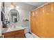 Bathroom featuring a wood vanity, an oval mirror, and a tub with an orange shower curtain at 210 N East St, Maitland, FL 32751