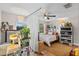 Bright bedroom featuring a ceiling fan, wood flooring, and an open workspace with lots of natural light at 210 N East St, Maitland, FL 32751