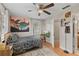 Bedroom with a ceiling fan, wood floors, and colorful decor; view of a connected bathroom at 210 N East St, Maitland, FL 32751