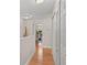 Hallway with hardwood floors and a partial view of a sitting room and three closets at 210 N East St, Maitland, FL 32751