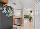 A well-lit kitchen with stainless steel dishwasher and refrigerator adjacent to the cozy living room at 210 N East St, Maitland, FL 32751