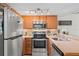 Well-lit kitchen featuring stainless steel appliances and ample cabinet space at 210 N East St, Maitland, FL 32751