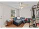 A bright living room with tile floor, a blue sectional, and a ceiling fan at 210 N East St, Maitland, FL 32751