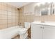 Bathroom featuring a shower-tub combo, neutral tile, and a vanity with a mirror at 225 Ranier Cv # 105, Casselberry, FL 32707