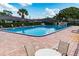 Community pool with brick paved deck and lounge seating area at 225 Ranier Cv # 105, Casselberry, FL 32707