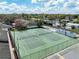 Aerial view of fenced tennis courts in a residential area with a bright sunny sky at 225 Ranier Cv # 105, Casselberry, FL 32707