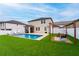 Backyard view featuring a sparkling pool, lush landscaping, pergola, and stylish lounge chairs at 2273 Lost Horizon Way, Clermont, FL 34715