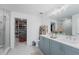 Modern bathroom featuring a double vanity, walk-in glass shower, and a walk in closet at 2273 Lost Horizon Way, Clermont, FL 34715