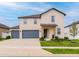 Beautiful two-story home with a two-car garage, a well-manicured lawn, and lovely landscaping at 2273 Lost Horizon Way, Clermont, FL 34715