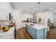 Modern kitchen with stainless steel appliances, a center island, and white cabinetry at 2273 Lost Horizon Way, Clermont, FL 34715