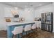 Bright kitchen featuring stainless steel appliances, a large island, and bar stool seating at 2273 Lost Horizon Way, Clermont, FL 34715