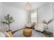 Bright living room with two chairs, a round rug, and a decorative potted tree at 2273 Lost Horizon Way, Clermont, FL 34715